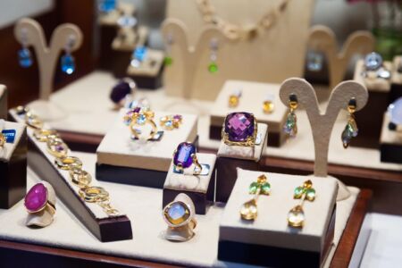 Gold jewelry with gems at showcase