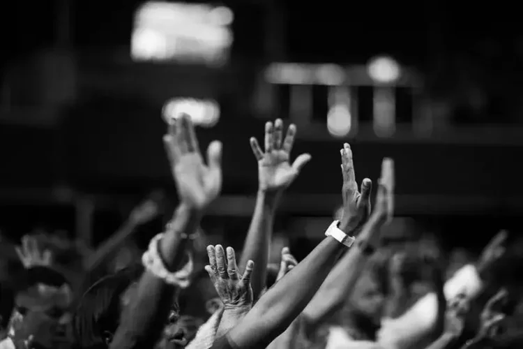 people raising hands to find a church